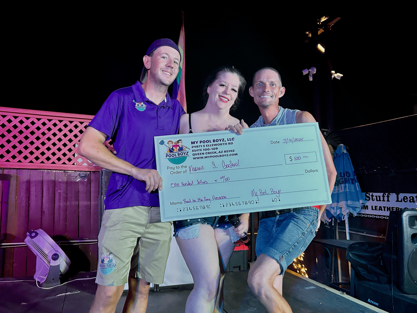 Phoenix arizona Arizona Gay Rodeo Association member being awarded 100 dollars by My Pool Boyz